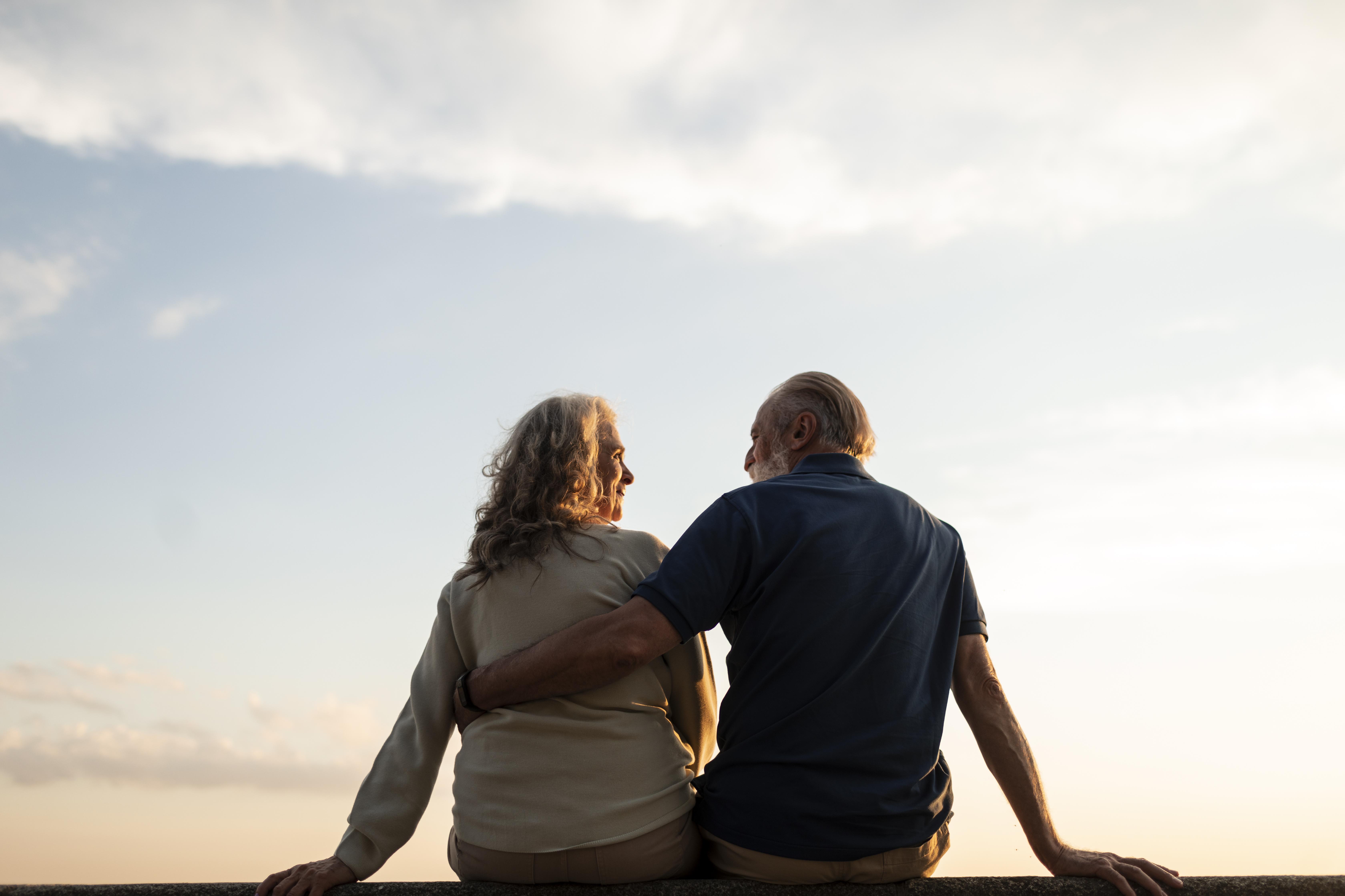 retired couple watching the sunset